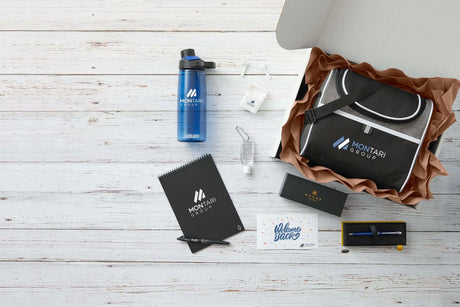 A new hire onboarding kit featuring a branded backpack, CamelBak water bottle, spiral notebook, Cross pen set, earbuds, hand sanitizer, and a welcome card.